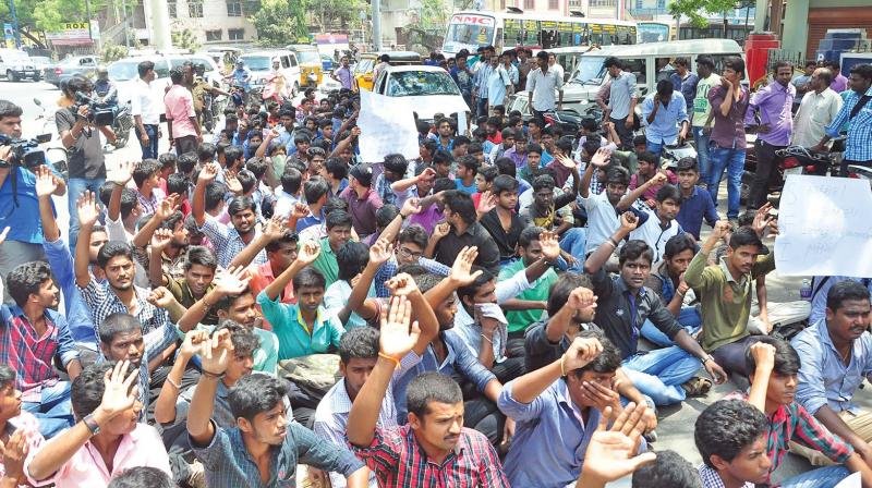 Students of a private college staging a protest in front of district collectrate in Coimbatore on Friday demanding a fair probe and action against the college administration, after a student committed suicide inside the hostel.