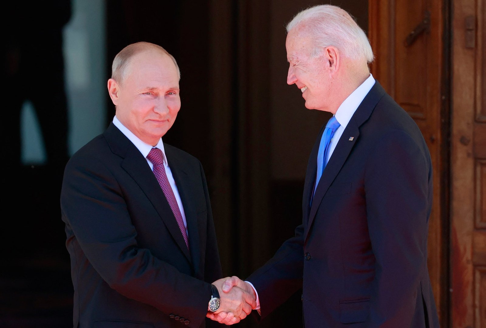 Joe Biden shakes hands with Vladimir Putin at a summit in June.